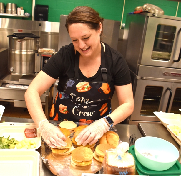 Assistant Cook Heather Palmieri makes chicken sandwiches for lunch in the SPC cafeteria.