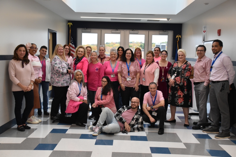 CTI staff gather for a photo on Pink Out Day in honor of Breast Cancer awareness