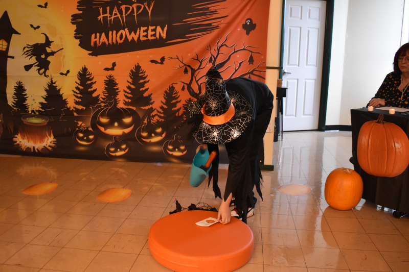 The Witch attempts to pick the pumpkin.