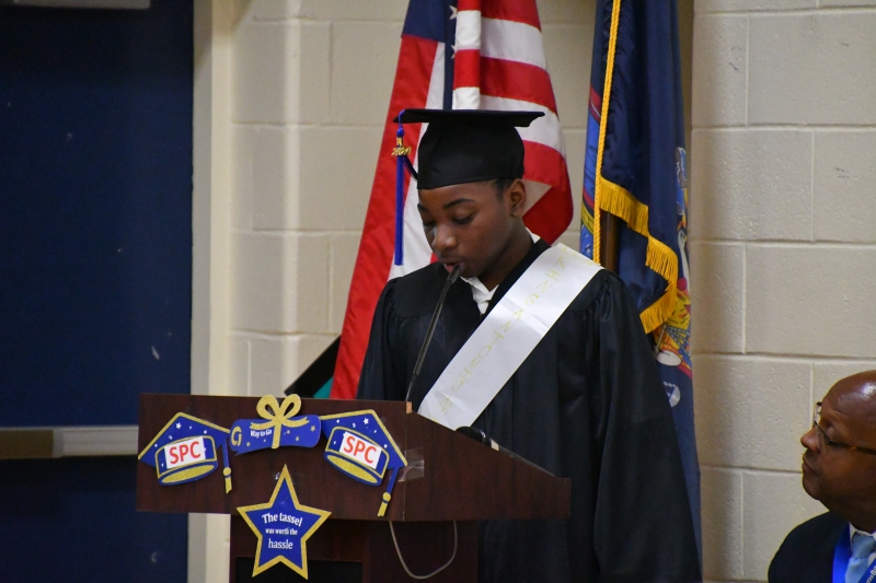 Kyle Mills reads "Still I Rise," a poem by Maya Angelou during the ceremony.