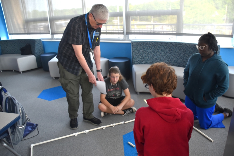 DCC Career Coach Joseph Reilly speaks to a group about their 'Bug Out' design.