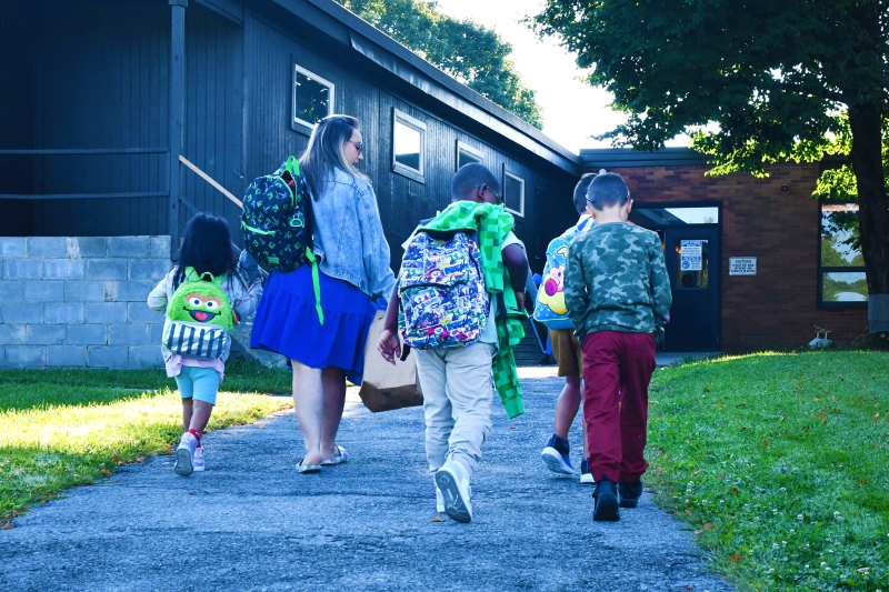 SPC students are escorted to their classroom on the first day.