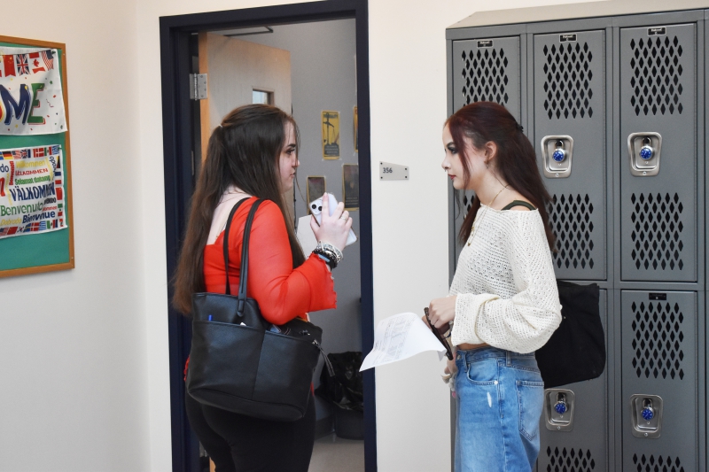 Resilience Academy students talk by lockers