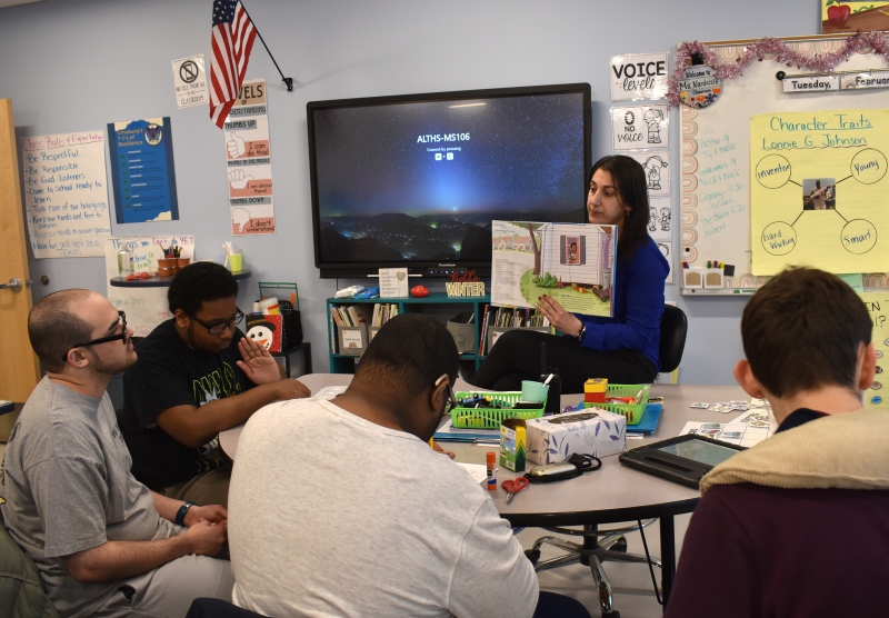 Resilience Academy teacher Krystine Nardozzi reads a book to students during Black History Month