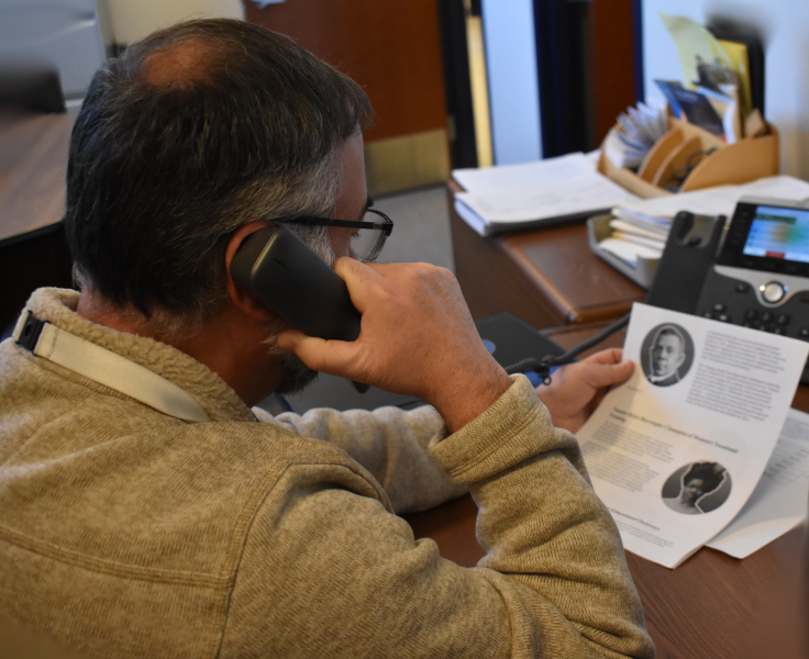 CTI Principal Nick Millas reads a profile of Nannie Helen Burroughs during announcements.