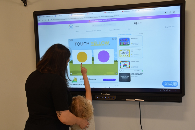 A student selects a color from choices on a Promethean board.