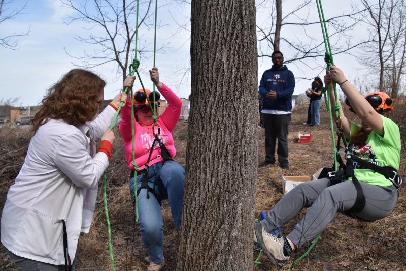 Students in the Careers in Animal and Plant Sciences program climb trees before break as part of a class activity.