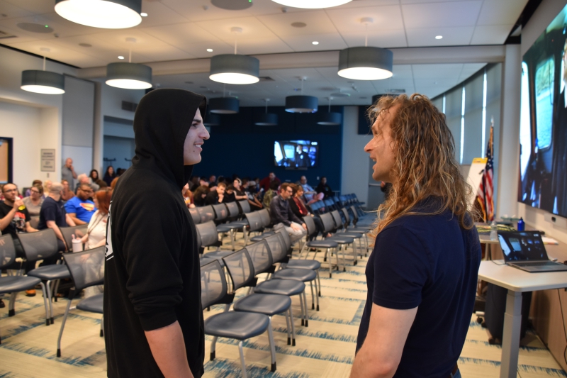 A Resilience Academy student speaks with Nick Tokman before the presentation begins.
