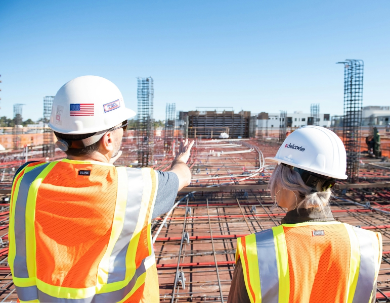 Construction workers wearing safety vests and headgear