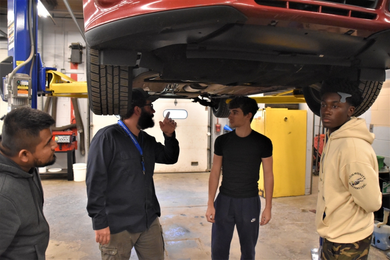 Teacher Mark Kuczyra speaks to students, including Antonio Perez, during a class.