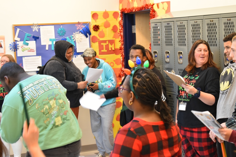 Mia Fountain, in light blue sweatshirt, sings with the group as they move through halls at the Resilience Academy.