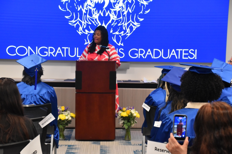 Guest Speaker Heather Ann Pitcher, CEO and founder of Brain and Body Coalition, speaks to the graduates.