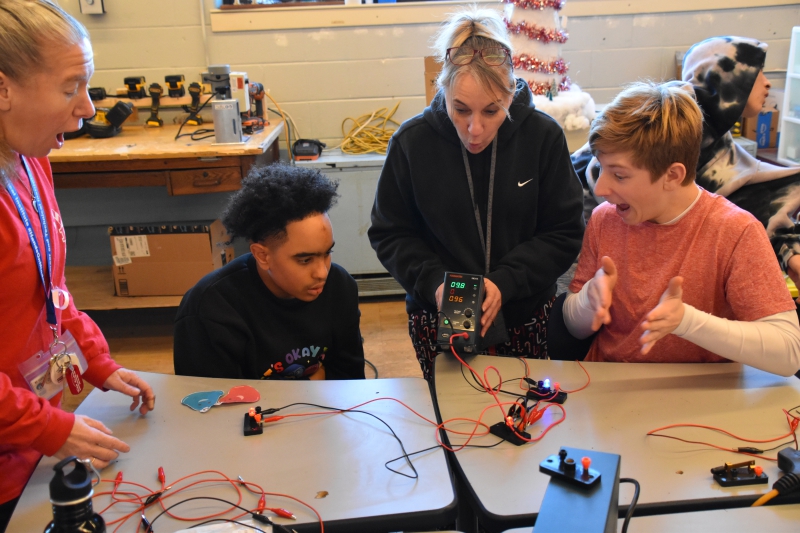 Students in April Hart's Resilience Academy class are excited after completing a circuit which lit red and green lights during a visit to CTI's Trade Electric program.