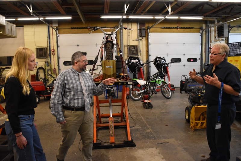 Small Engines Instructor Pete Hruscik speaks with representatives from Adams Fairacre Farms