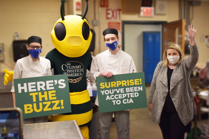 Culinary students Maison Migliore and Ashley Kayse-Hughes pose with CIA Mascot, Sting.