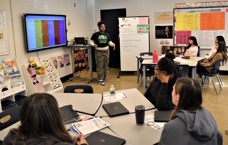 Early Childhood Education Student Leya Greene presents a lesson plan about flowers to classmates and CTI teachers.