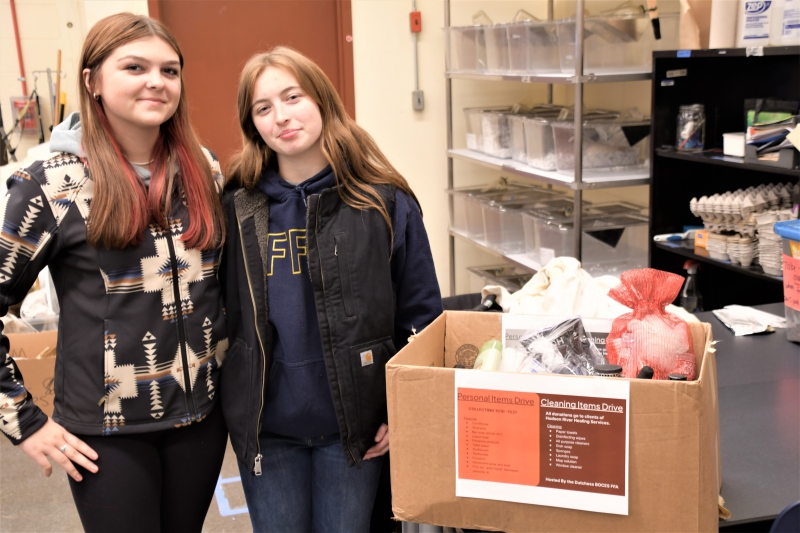 FFA members Elianna Fell and Leah Vinchiarello with a box of hygiene and cleaning items that were donated