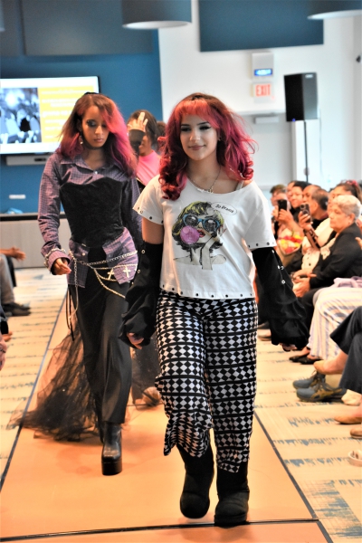 Models sporting a variety of clothing designed by students walk the runway.