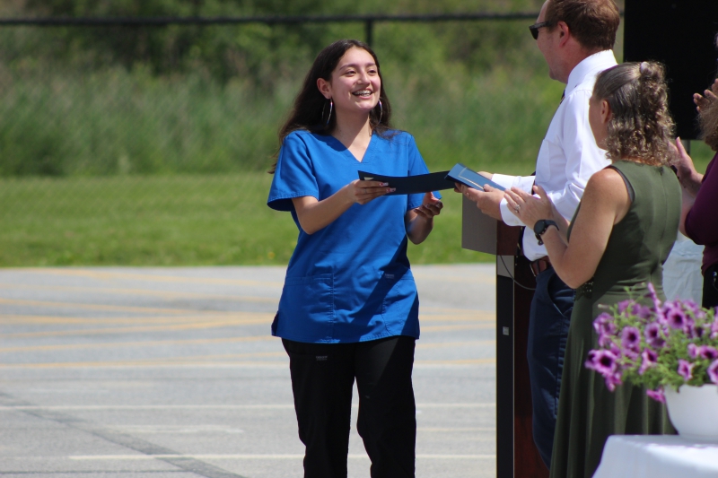 Nursing assistant student Yamatha Lozada accepts her completion certificate.