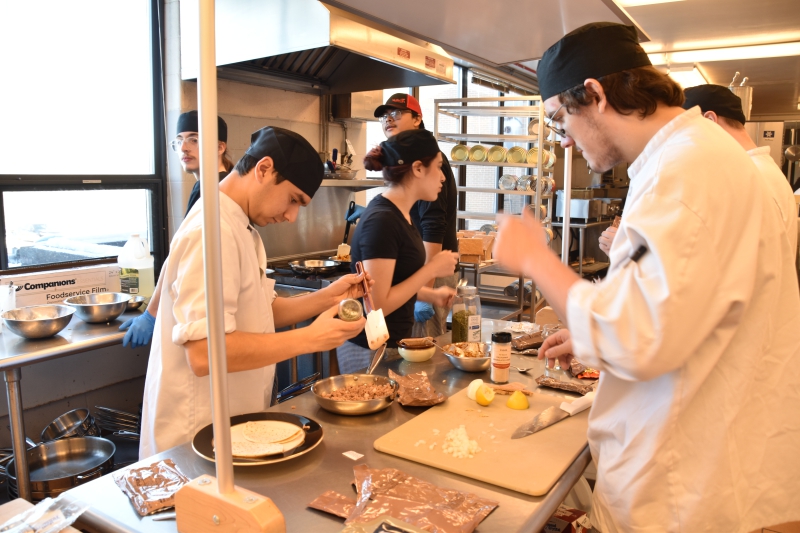 Students prepare meals using contents of an MRE for the MRE Challenge.