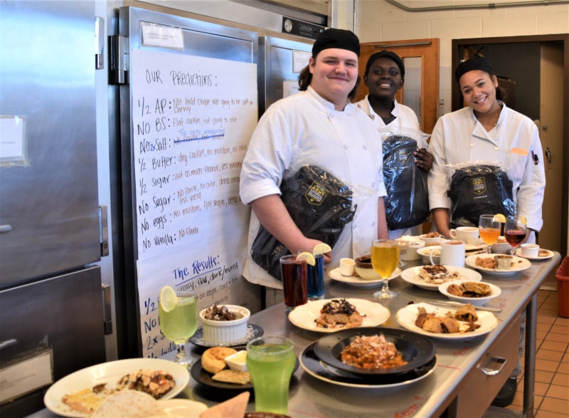 Group five members Kenan Oflu, Ella Watkins and Marley Bennett show off the backpacks they earned for winning the competition. Group member Donavyn Greenhaw is not pictured.