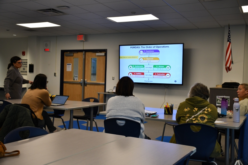 Arlington Central School District ENL Coordinator Eliza Kondzielaski shows how AI helped create a slide to explain the order of operations to English Language Learners.