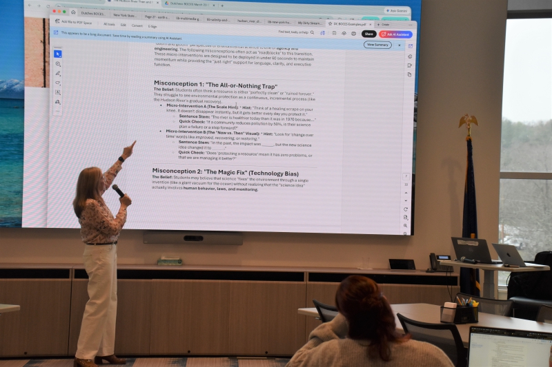 Keynote speaker Dr. Andrea Tejedor talks about misconceptions surrounding AI as she points to a slide on the topic.