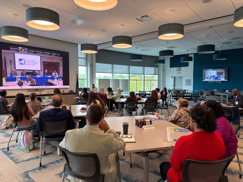 Students seated in conference room at Dutchess BOCES viewing a live panel discussion on a video screen related to being an Ex Officio Student Board Member. 