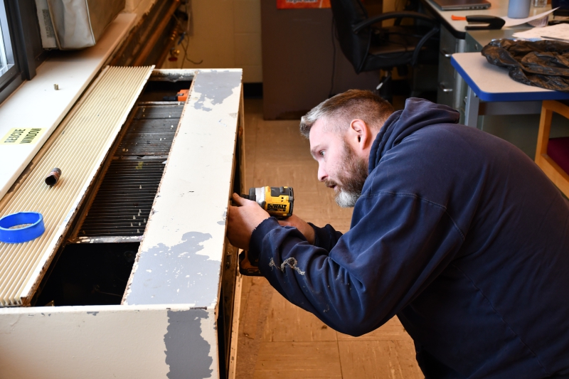 Jim Quick of Ashley Mechanical Inc. in Kingston works on the heating system at Salt Point Center. It was one of the projects done by staff and contractors while students were off for the holiday break.