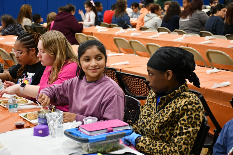 Students talk while enjoying the Thanksgiving lunch