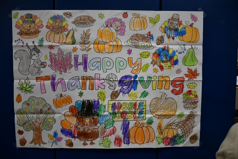 Students colored a Happy Thanksgiving poster for the event.