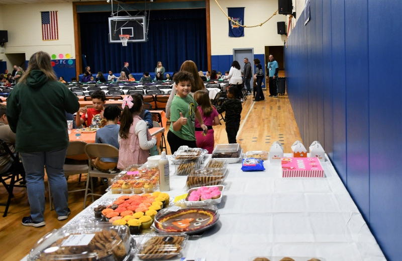 Student Tre Laureno gives a thumbs up to the dessert table