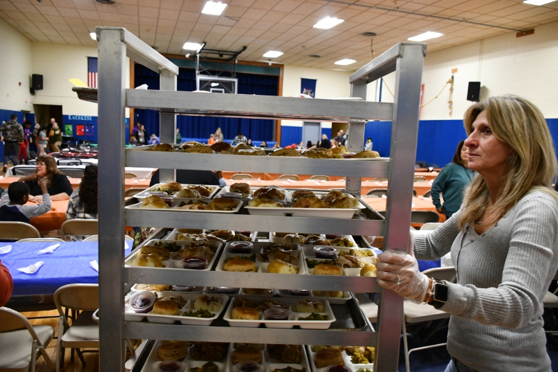 Staff members serve Thanksgiving lunch.