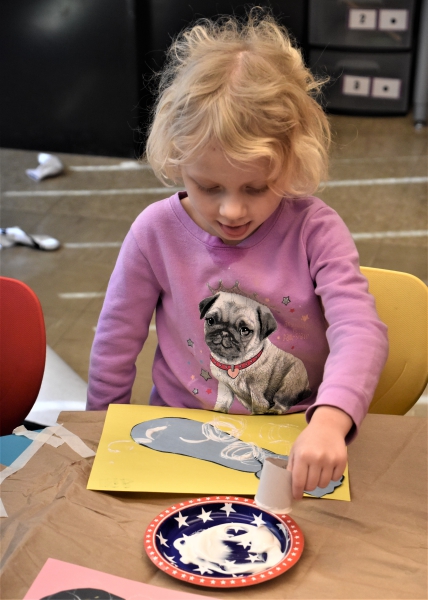 SPC student Harley makes Olympic rings as part of a craft.
