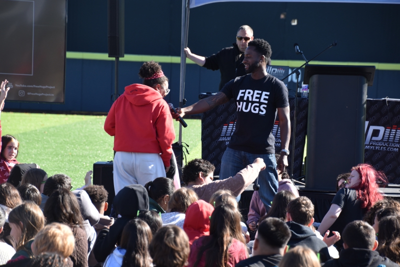Motivational speaker Ken Nwadike, Jr., the "Free Hugs Guy" has a student speak during the Dutchess Youth Health Rally.