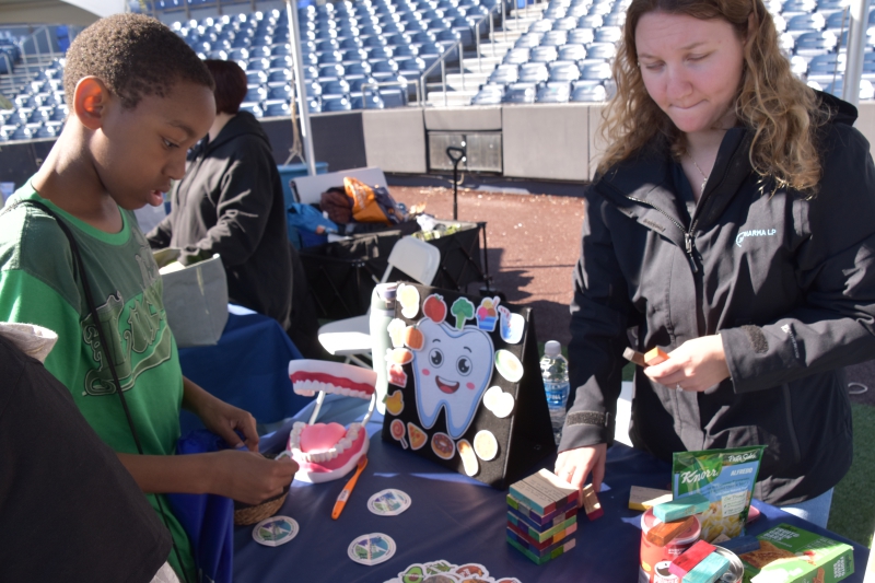 An SPC student checks out resources at the dental health table during the Dutchess Youth Health Rally at Heritage Financial Park