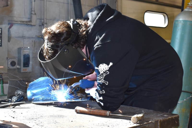 student welds his sculpture for SkillsUSA competition